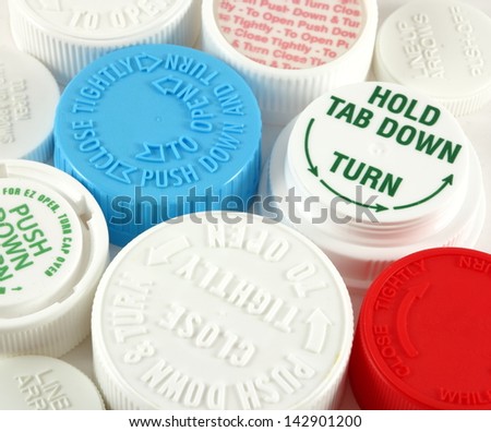 Collage of medicine bottle safety caps on a white background