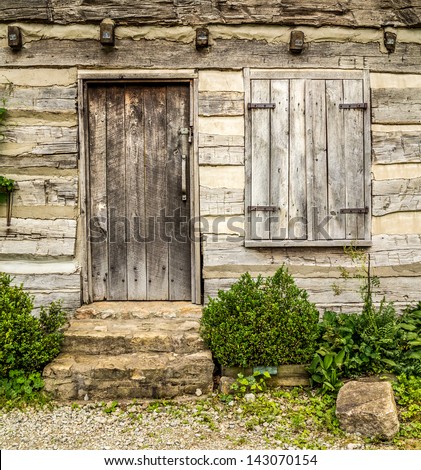 Rustic wooden door and shutters on a very old house
