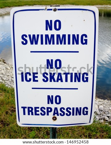 Blue and white No Swimming, No Ice Skating, No Trespassing sign
