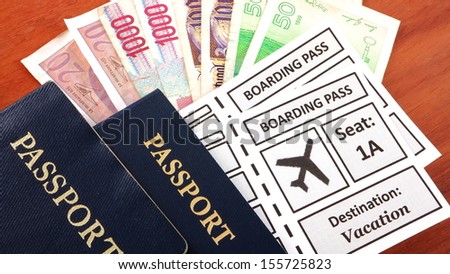 Passports with airline boarding pass and foreign currency
