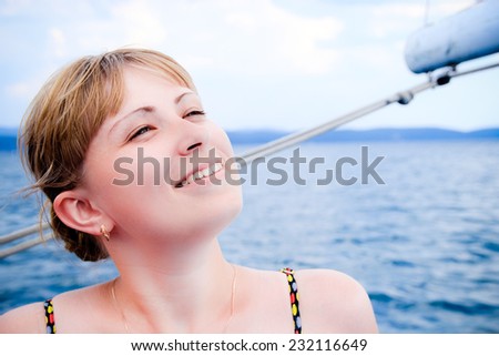 Girl cruising yacht on the sunny and warm day at one of the most beautiful and clean lake on the Earth