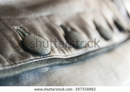 buttons on the black leather vest