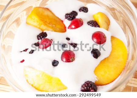 peach slices and berries in ice cream