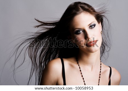 Attractive brunette with flying hair in the wind