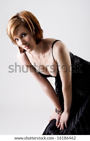 stock photo : Short-hair fashion model in black dress showing cleavage