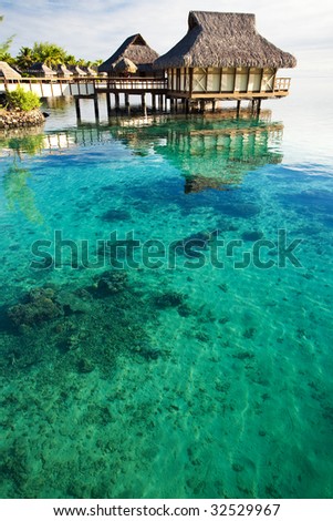 Over water bungalows over amazing lagoon with coral
