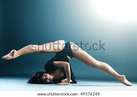 Young contemporary female dancer doing splits in the air