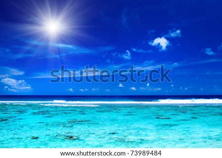 Sun and sky over tropical ocean with vibrant colors