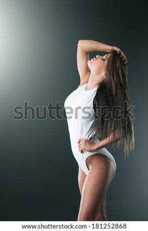 Slim healthy woman looking after her figure, profile
