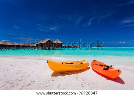 Two colourful kayaks on the tropical beach