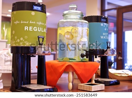 Refreshment Dispensers Coffee, hot water and lemon water displayed in colorful dispensers placed on a table