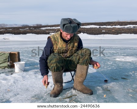 A winter fishing on river. People is fishing the smelt.