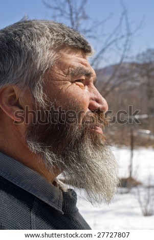 A portrait close up of the old men with grey beard. Small indigenous people of Russian Far East.