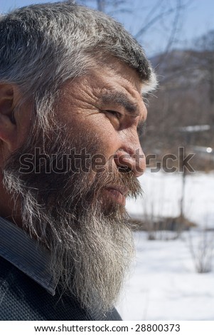 A portrait close up of the old men with grey beard. Small indigenous people of Russian Far East.