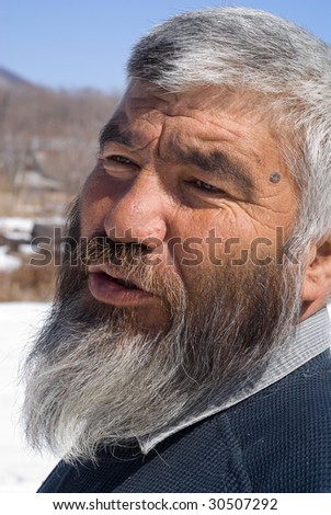A portrait close up of the old men with grey beard.