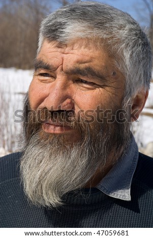 A portrait close up of the old men with grey beard. Small indigenous peope of Russian Far East.