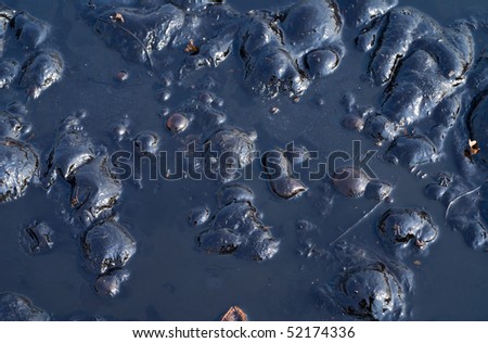 A close-up of the surface of black oil pollution.
