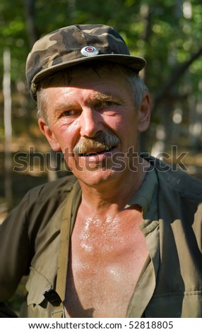 A portrait close up of the very sweated man in forest.