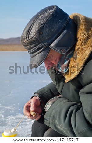 An old man on winter fishing.