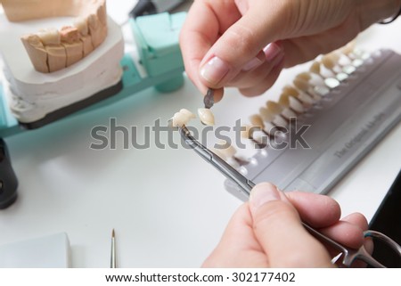Check color of tooth crown in a dental laboratory
