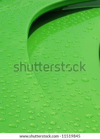drops of water on the spoiler of a green car