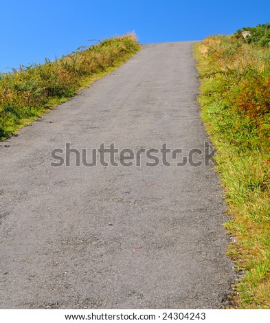 uphill road seeming to end abruptly jumping into the sky