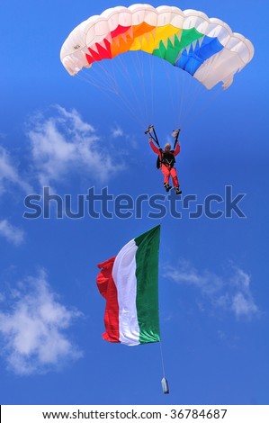 BRESCIA, ITALY - SEPTEMBER 6: sport parachutist in mid-air with large italian flag during Brixia Air Show.  on September 6, 2009 in Brescia