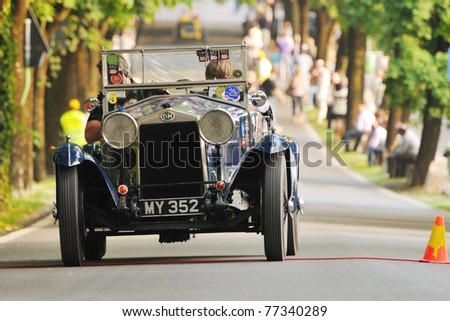 BRESCIA, ITALY - MAY 12 : A 1928 built blue OM 665 Superba car meets a control in transit point  (time check in a regularity race) during 1000 Miglia race on May 12, 2011 in Brescia.