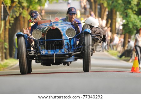 BRESCIA, ITALY - MAY 12 : A 1926 built blue Bugatti type 35 car meets a control in transit point (time check in a regularity race) during 1000 Miglia race on May 12, 2011 in Brescia.
