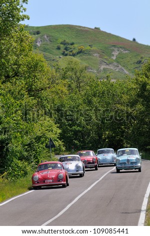 RADICOFANI (SI) ITALY - MAY 19: five red gray and pale blue Porsche and Alfa Romeo classic cars take part to the 1000 Miglia 2012, on May 19, 2012 in Radicofani (SI)
