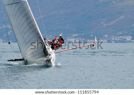 GARGNANO (BS) ITALY - SEPTEMBER 2: Stravaganza sailing boat, skipper Carlo Fracassoli, cuts the finish line and wins the Trofeo Gorla regatta, on September 2, 2012 in Gargnano (BS)