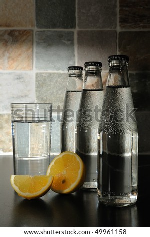 Bottle with mineral water and a lemon