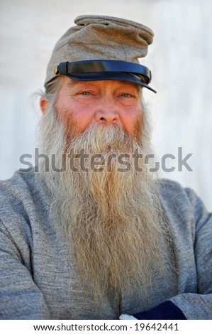 Portrait of old soldier in confederate uniform wearing long white beard