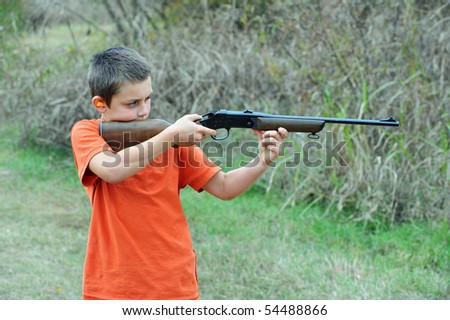 Boy shooting rifle