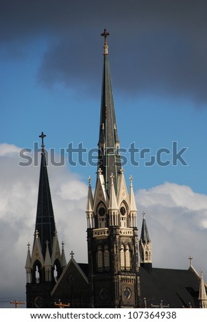 Church steeples stand out against an ominous sky