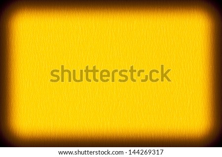 Background texture of bright yellow fabric closeup with vignette
