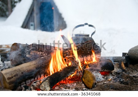 Rustic campfire in winter at the polar circle