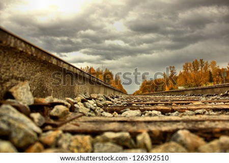 Train tracks leading into the fall colored mountains of interior Alaska.