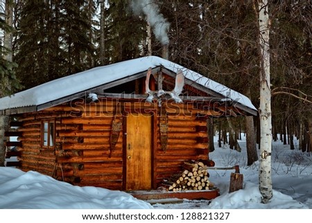 A remote log cabin during winter in Alaska\'s interior.