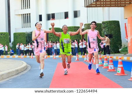 BANGKOK, THAILAND - DECEMBER 20 : old runners in the over 54 years old class help each other at the finish point in running telecom event 2013 on December 20, 2012 in Bangkok, Thailand.