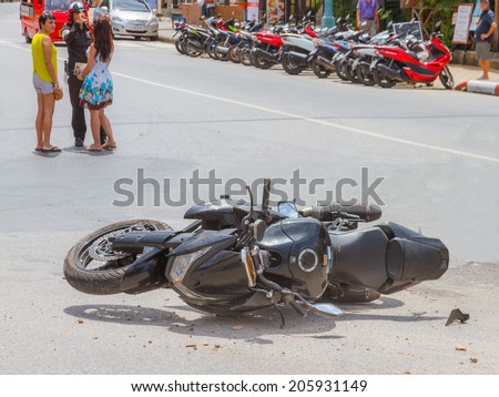 Patong, Phuket, Thailand - July 20 : The motorcycle crash a car at Rauthit Songroipi Road. on July 20, 2014 in Patong, Phuket, Thailand.