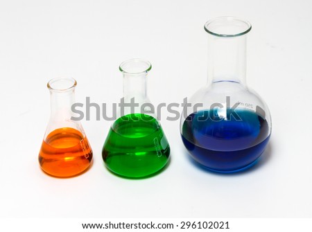 Group of laboratory flasks empty or filled with a clear liquid on white background.