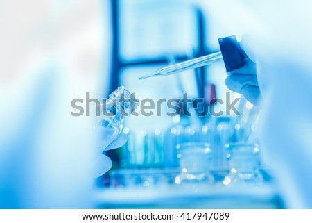 The scientist test in lab or science research,science concept,science education.Scientist work in process at laboratory,Science experiments and selective focus,Science laboratory test tubes.