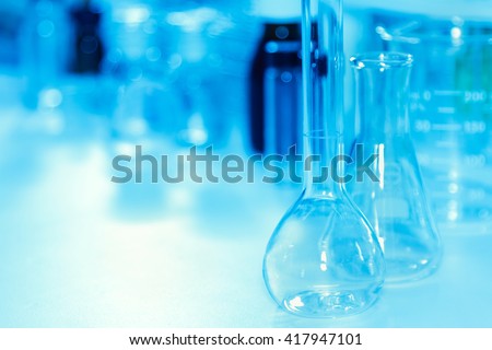 The scientist test or research for decorate or design science concept,science content,science concept,science background,Scientist female working in lab and looking test tube,science education.
