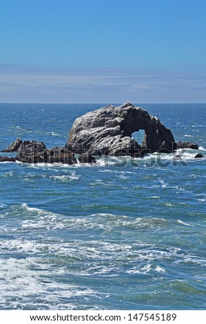 A natural bridge at the Seal Rocks near Ocean Beach in San Francisco. The rough sea and rocks near the shore have caused many ship wrecks. Seals hang out on the rocks.