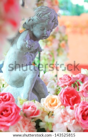 Cupid statue with flowers