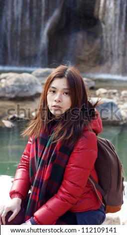 Girl the innocent face look at front view without make up (makeup) in Lijiang waterfall