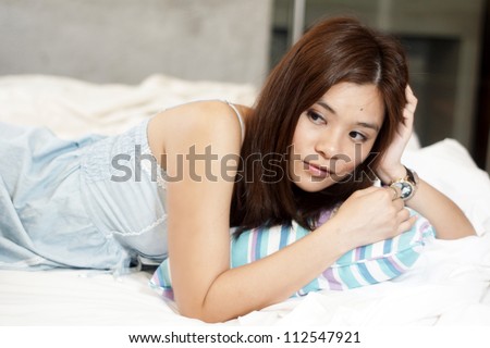 long hair asian model with different pose on the bed sleepy don\'t want to wake up