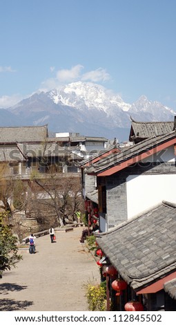 jade dangon snow mountain behind the street of  lijiang old town, the world heritage site of UNESCO