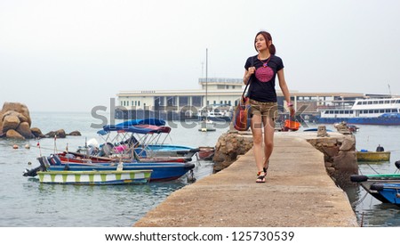 girl walking on the pier with the sea background ,nature style in hong kong Lamma Island countryside